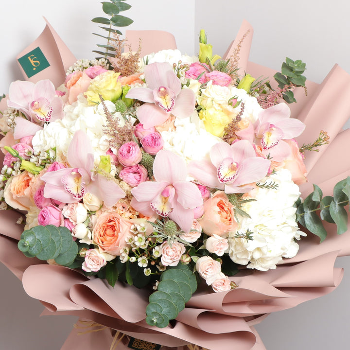 present with pink roses in Dubai